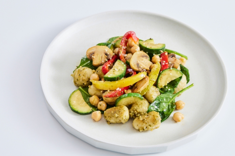 a plate of veggie gnocchi with colorful vegetables